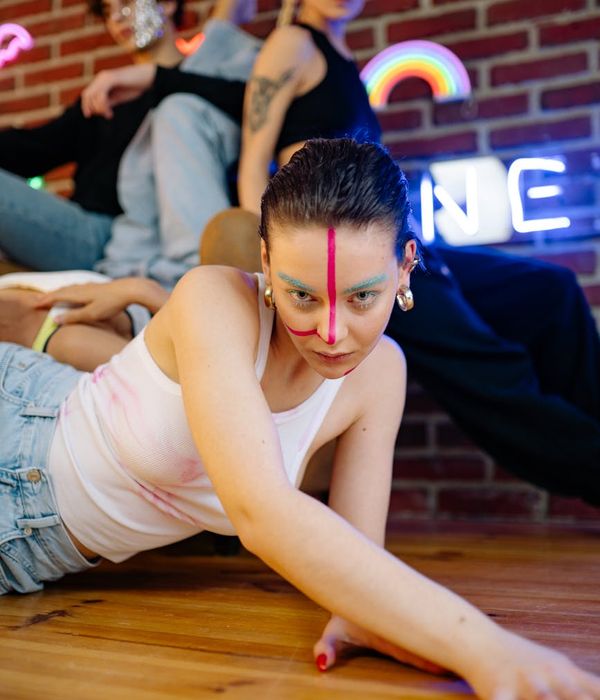 Woman in a dynamic and energetic pose against a clean background.